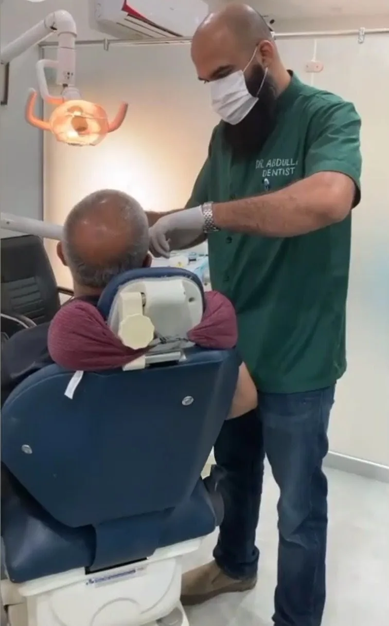 Dr. Abdullah Karamat treating a patient at Smile Hub Clinics